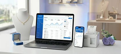 A jewellery business dashboard shown on a laptop, tablet and phone beside a necklace